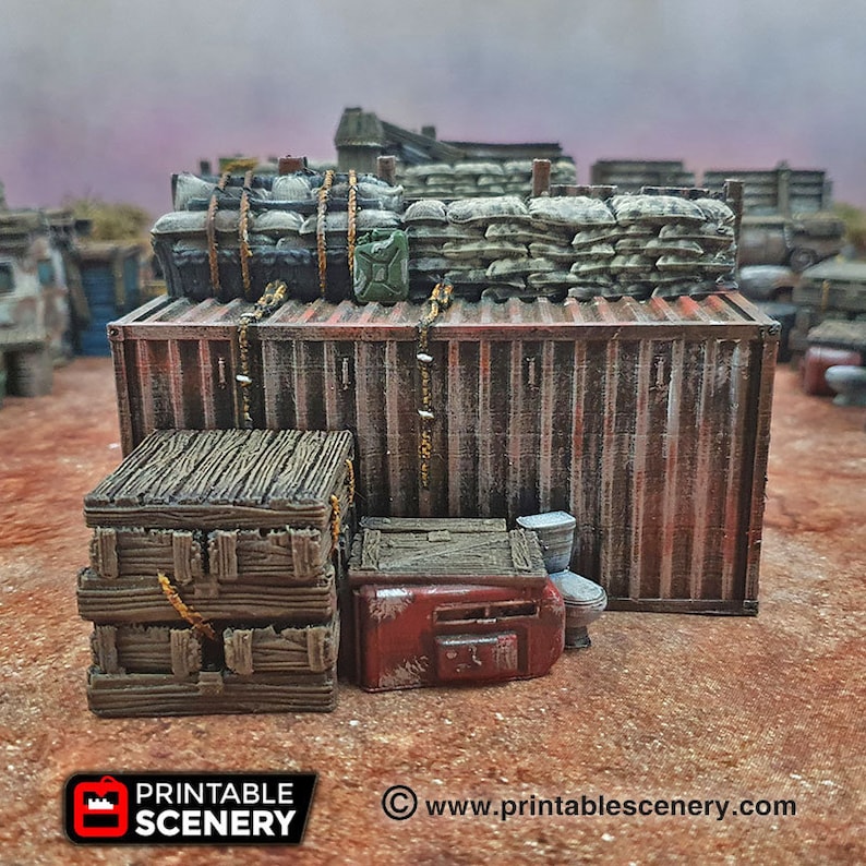 May include: A weathered, rusty shipping container with a stack of wooden crates and a red, rusty metal object in front of it. The container is topped with a pile of sandbags and a few barrels.