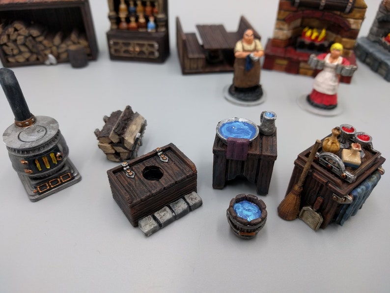 May include: A collection of miniature wooden furniture pieces, including a table with a blue bowl, a small wooden chest, a wood-burning stove, and a wooden cart with a broom and other items. The pieces are painted in brown, grey, and blue tones.