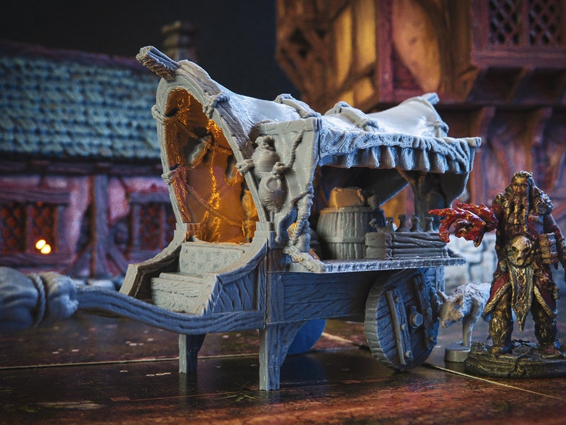 May include: A grey wooden wagon with a canvas top and a wooden barrel inside. The wagon has two wheels and a long tongue. The wagon is sitting on a wooden surface.