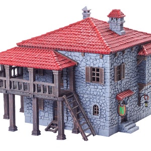 May include: A grey stone building with a red tiled roof and a wooden balcony. The building has a wooden ladder leading up to the balcony and a sign with a green shield hanging on the side.