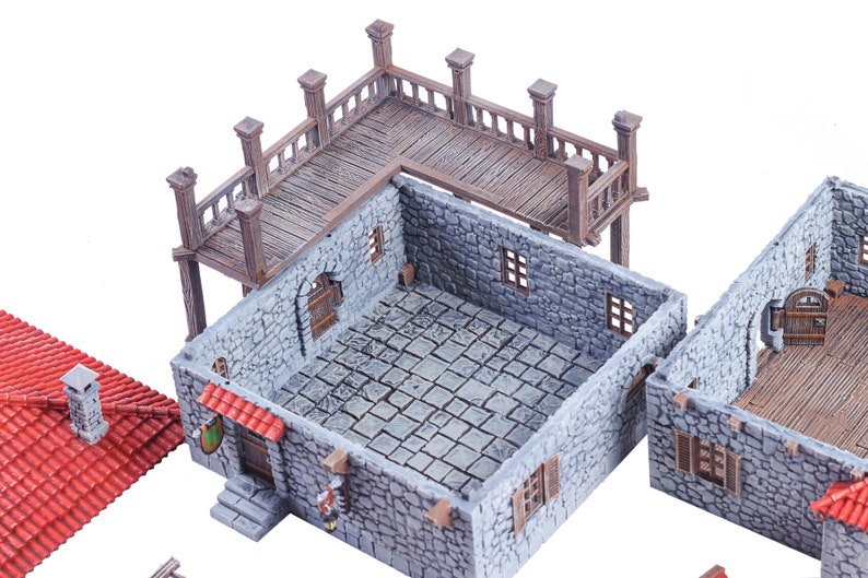 May include: A set of miniature stone building structures with a wooden balcony and red tile roof. The buildings are designed for tabletop gaming and role-playing.