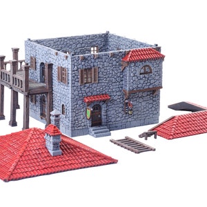 May include: A grey stone building with a red tiled roof, a wooden balcony, and a ladder. The building is a miniature model for tabletop gaming.