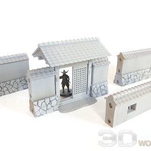 May include: A set of five gray plastic miniature castle walls with a gate and a roof. The walls are made to look like stone and have a textured surface. The gate has a wooden door with a lattice design. The roof is made of tiles and has a slight curve. The walls are designed for use in tabletop games and role-playing games.