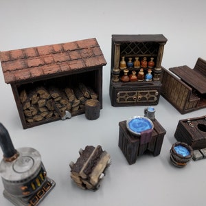 May include: A collection of miniature wooden furniture and accessories for tabletop gaming, including a wood-burning stove, a woodpile, a small table with a blue bowl, a wooden bench, a small wooden shed, and a cabinet with shelves filled with potion bottles.