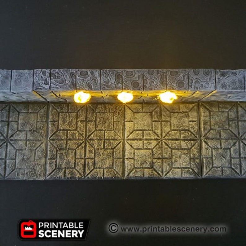 May include: A close-up of a gray stone wall with three small, glowing lights. The wall is made of square blocks with a textured surface. The lights are evenly spaced and cast a warm glow.