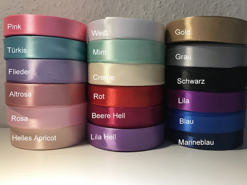 May include: A collection of 18 satin ribbon spools in various colors, including pink, turquoise, white, mint, gold, gray, lavender, cream, black, light pink, red, purple, burgundy, light pink, blue, peach, light purple, and navy blue.