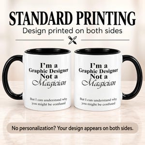 Two views of the same black accent mug showing the “I’m A Graphic Designer, Not A Magician” design printed on both sides.