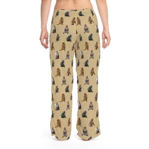 May include: Tan pajama pants with a repeating pattern of various monkey illustrations in shades of brown, gray, and tan. The pants are loose-fitting and made of a soft material.