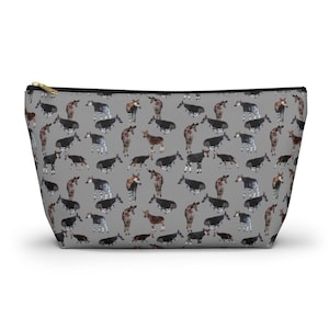 May include: A gray zippered pouch with a repeating pattern of black and white okapi illustrations.