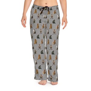 May include: Gray pajama pants with a repeating pattern of various monkey illustrations. The pants have a drawstring waist and a relaxed fit. The monkeys are depicted in different colors and poses.