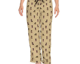 Puede incluir: Pantalón de pijama beige con un patrón repetido de pequeños perros negros y marrones. El pantalón tiene una cintura con cordón negro.
