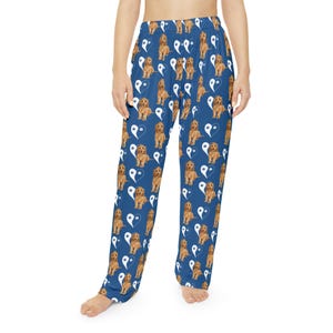 May include: Blue pajama pants with a repeating pattern of brown dogs and white yin-yang symbols. The pants are made of a soft material and have a relaxed fit. The pajama pants are suitable for lounging or sleeping.