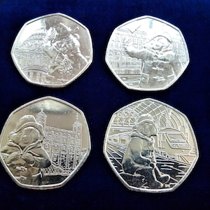 Set:4x Paddington Bear 50p Coins - St Paul&#39;s Cathedral , at the Station,Tower of London,at the Palace.Uncirculated