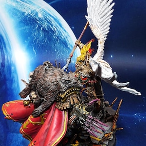 May include: A detailed miniature figure of a warrior with a bear-like head, red cape, and ornate armor. A winged figure with a spear is positioned above. The figures are set on a rocky base against a space-themed backdrop.