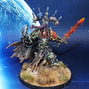 May include: A detailed miniature figure of a warrior in black and green armour, holding a fiery red sword. The figure has a skull-adorned helmet and cape, standing on a textured base with grass. The background is a blue gradient with a planet.