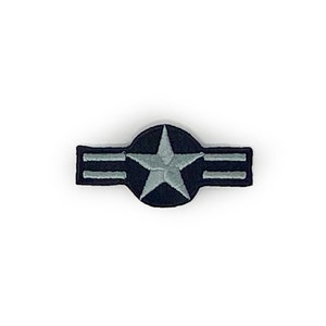 May include: A blue and silver embroidered patch with a star in a circle and three stripes. The patch is a military insignia.