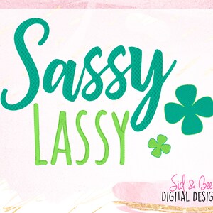 May include: Sassy and Classy text with green shamrock designs. The text is in a green and teal color scheme. The text is on a white background. The text is in a cursive font. The text is surrounded by a pink and gold watercolor background. The text is from Sid & Bee Digital Designs.