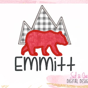 May include: Red bear applique with a mountain range behind it. The mountains are made of gray and white checkered fabric. The name "Emmitt" is written in black below the bear.