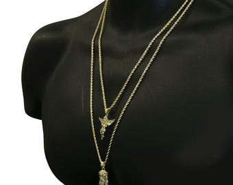May include: Three gold chains with pendants. The top chain has a small angel pendant. The middle chain has a larger angel pendant. The bottom chain has a Jesus pendant.