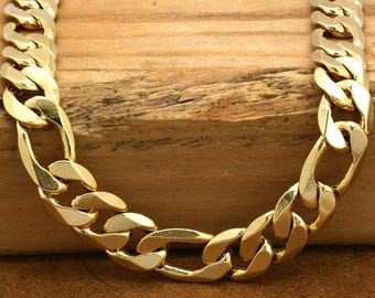 May include: A gold curb chain necklace with a thick, flat link design. The chain is made of a shiny metal and has a smooth finish.