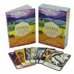 May include: A set of Chakra Wisdom Oracle Cards with a guidebook. The cards feature colorful illustrations and the text "Chakra Wisdom Oracle Cards" and "The complete spiritual toolkit for transforming your life".