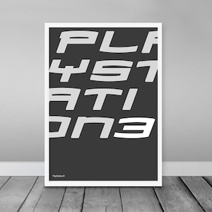 May include: A black and white poster with the text "PLAYSTATION 3" in a stylized font. The text is tilted at an angle and the letters are overlapping.
