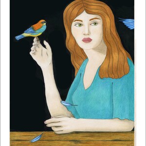 May include: A woman with long, red hair sits at a wooden table. She is wearing a teal blue dress and has a small, blue, yellow, and orange bird perched on her finger. The background is black with a few blue feathers scattered around.