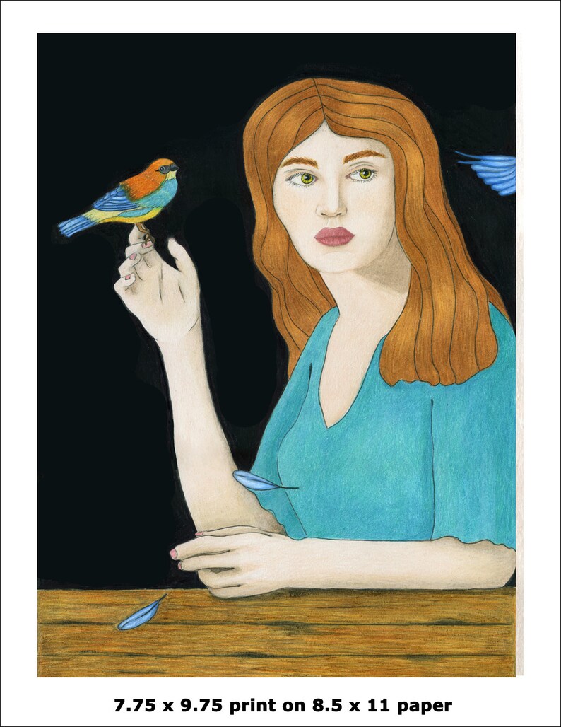 May include: A woman with long, red hair sits at a wooden table. She is wearing a teal blue dress and has a small, blue, yellow, and orange bird perched on her finger. The background is black with a few blue feathers scattered around.