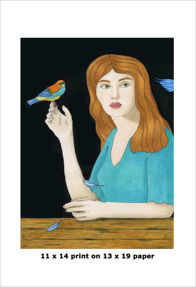 May include: A woman with long red hair sits at a table with a small blue and orange bird perched on her finger. The background is black and there are blue feathers scattered on the table.