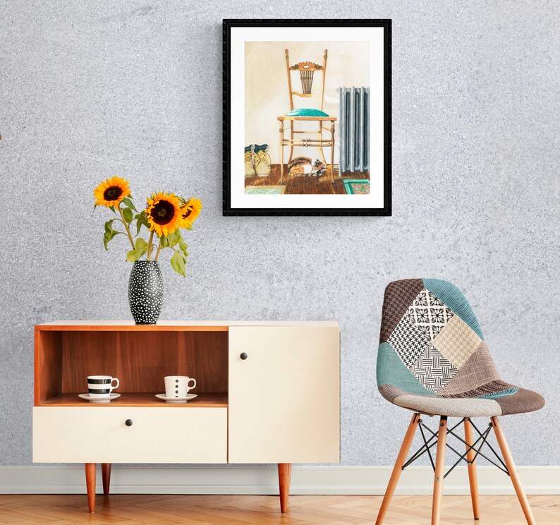 May include: A framed print of a vintage chair with a teal cushion, a radiator, and a pair of shoes on a wooden floor. The print is hanging on a light grey wall.