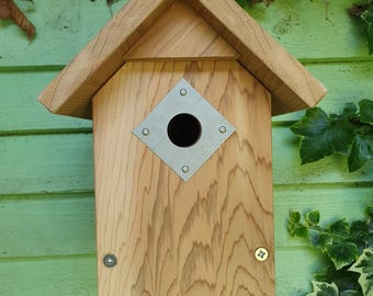 Wooden birdhouse in natural cedar