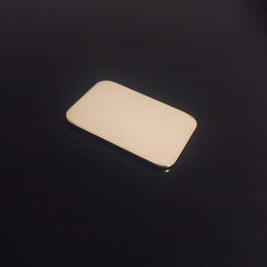 May include: A white rectangular makeup palette with a silver trim.