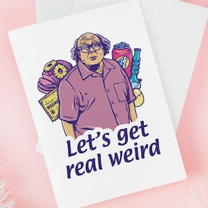 May include: A greeting card featuring a cartoon illustration of a man with curly brown hair and glasses, holding a variety of items including a can of Wolf energy drink, a bag of Trojan Magnum condoms, and a glass bong. The text "Let's get real weird" is printed below the image.