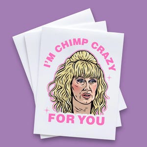 May include: A white card with pink text that reads "I'm chimp crazy for you". A cartoon illustration of a woman with blonde hair is in the center of the card.