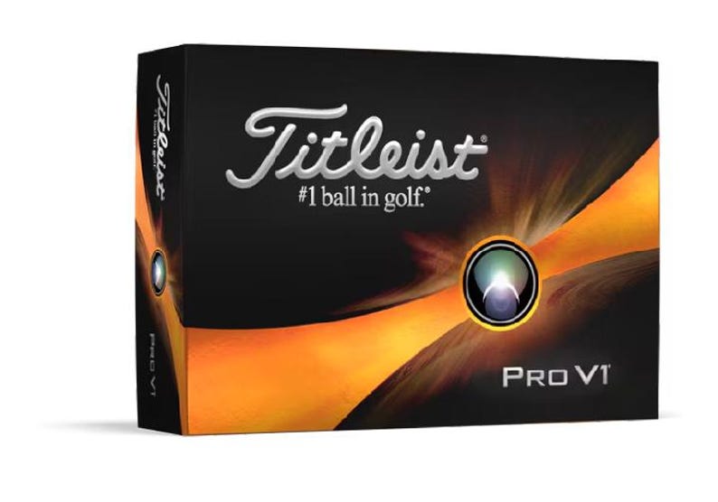 May include: A box of Titleist Pro V1 golf balls. The box is black with a gold and orange design. The Titleist logo is in silver and the text '#1 ball in golf' is below it. The words 'Pro V1' are in white on the bottom of the box.