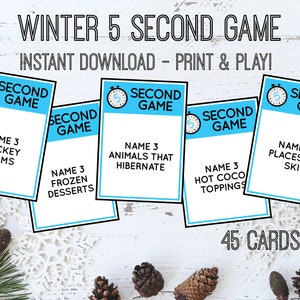 May include: A set of 45 blue and white cards with a winter theme. Each card has a timer icon and the text "Second Game". The cards have different winter-themed prompts, such as "Name 3 hockey teams" and "Name 3 places to ski".