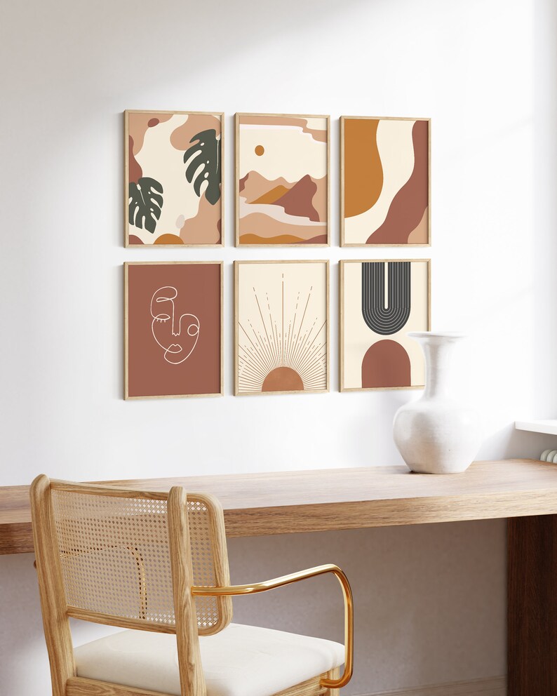 May include: Six minimalist abstract art prints in a gallery wall arrangement. The prints feature geometric shapes, line art, and organic forms in a warm colour palette of brown, orange, and cream. The prints are framed in natural wood frames and hung on a white wall.