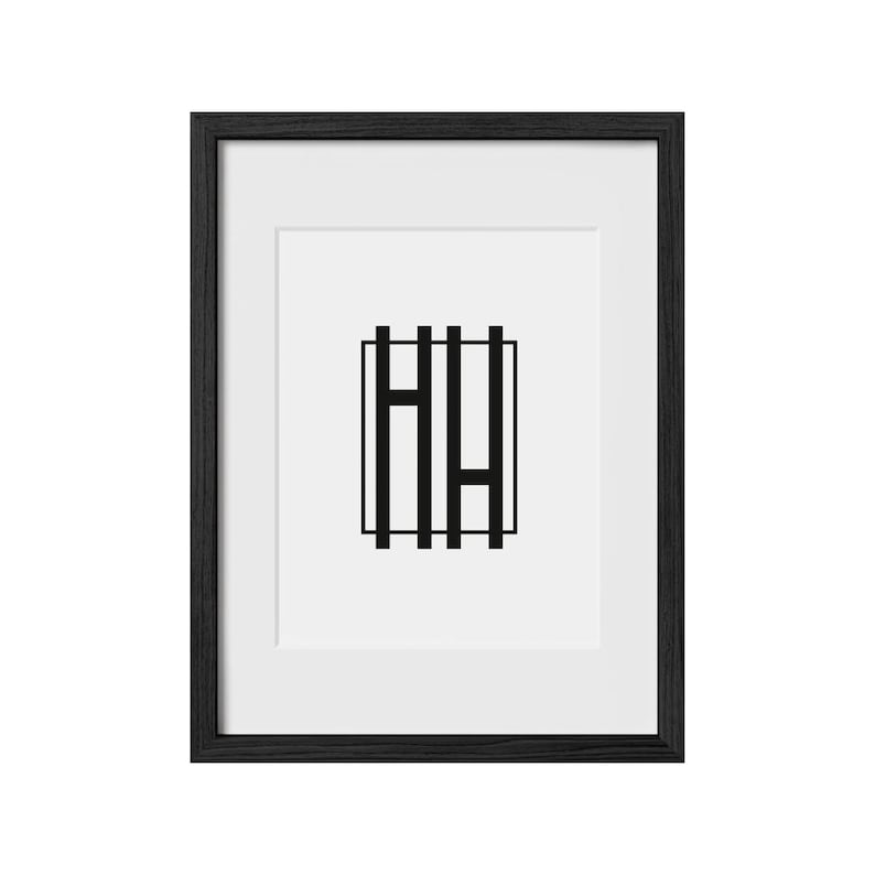 May include: A black framed picture with a white mat and a black and white graphic of the letters "HH" inside a square.