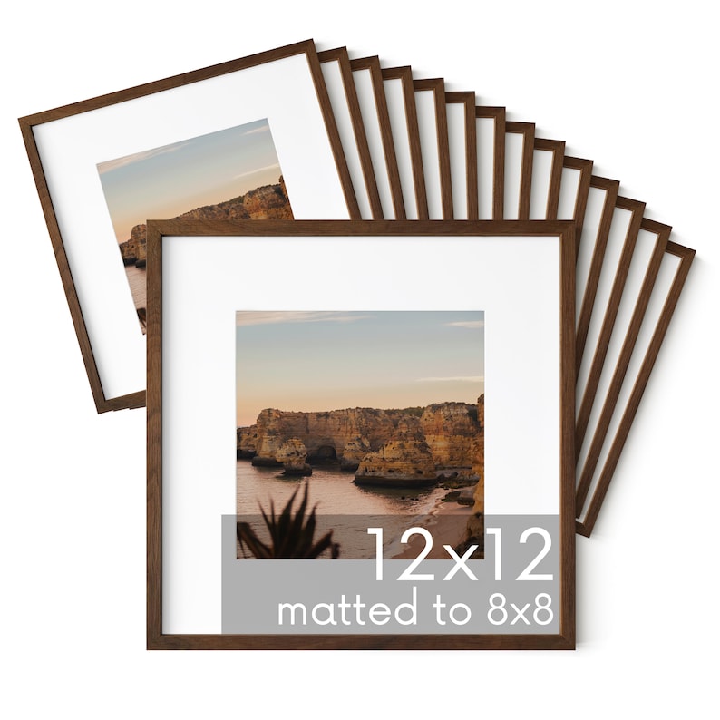 May include: A set of 12 brown wood picture frames, each measuring 12x12 inches, with a mat to fit an 8x8 inch photo. The frames are stacked in a fan shape, with the top frame showing a landscape photo of a rocky coastline.