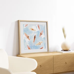 May include: A framed print of a watercolor painting depicting a pattern of women on surfboards against a blue and white background.