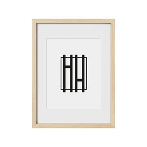 May include: A framed print with a black and white geometric design of the letters "HH" inside a square.