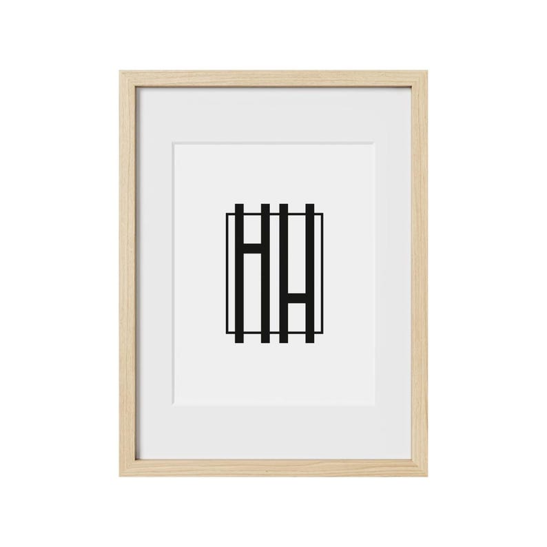 May include: A framed print with a black and white geometric design of the letters "HH" inside a square.