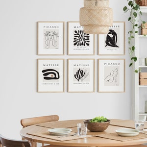 May include: Six framed art prints featuring black and white line drawings of people and abstract shapes. The prints are arranged in a grid on a white wall. The prints are titled "Picasso" and "Matisse" and include the text "The Can" and "Bergguen & Cie".