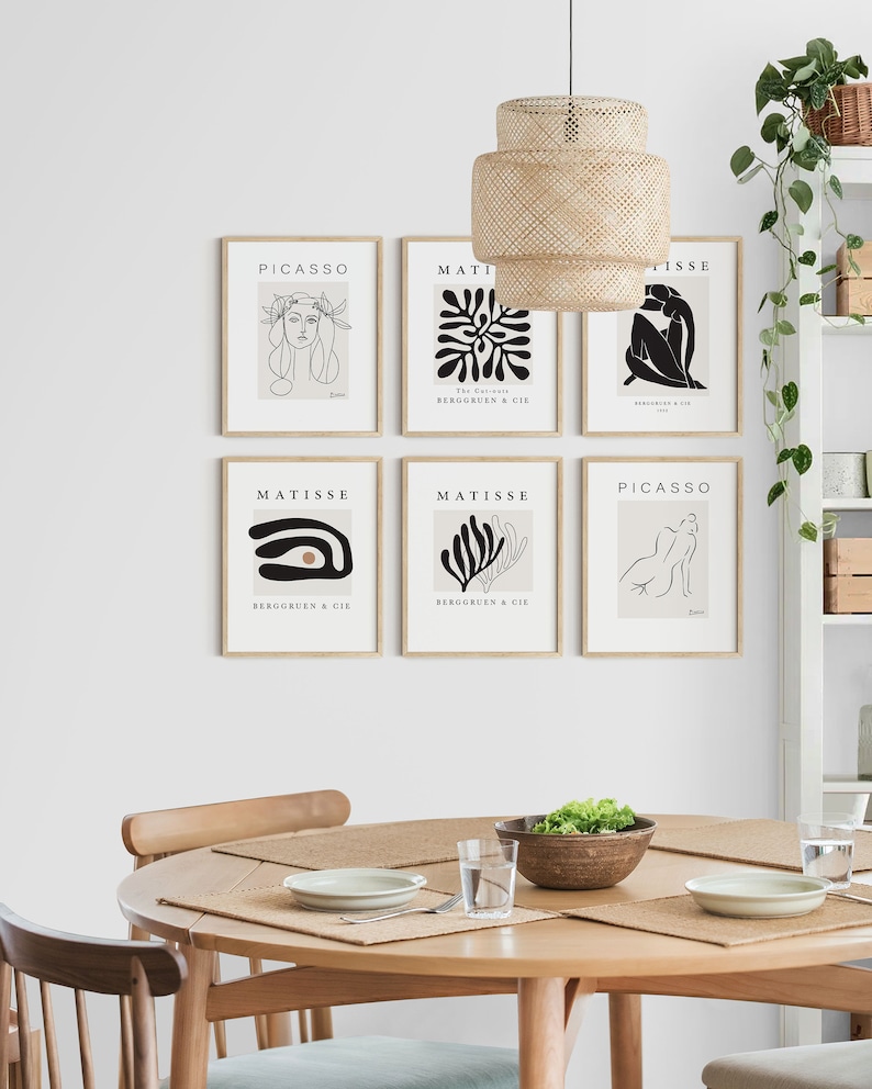 May include: Six framed art prints featuring black and white line drawings of people and abstract shapes. The prints are arranged in a grid on a white wall. The prints are titled "Picasso" and "Matisse" and include the text "The Can" and "Bergguen & Cie".
