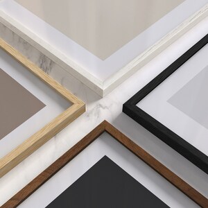 May include: Four picture frames in different colors and styles, arranged in a cross pattern on a marble surface. The frames are made of wood and metal, and they are all in different sizes.