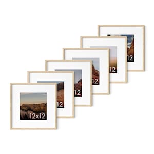 May include: Six square picture frames with natural wood-colored frames and white mats, each displaying a different landscape photograph. The frames are arranged in a diagonal line, with the size 12x12 inches visible on each. The photos feature scenic views.