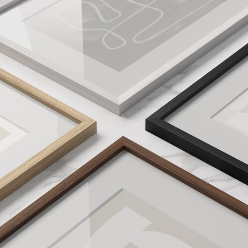 May include: Four different picture frames, each with a different color and style. The frames are arranged in a square shape, with the white frame at the top, the black frame to the right, the brown frame at the bottom, and the natural wood frame to the left.