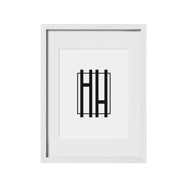 May include: A white framed print with a black graphic of the letters "HH" inside a square.