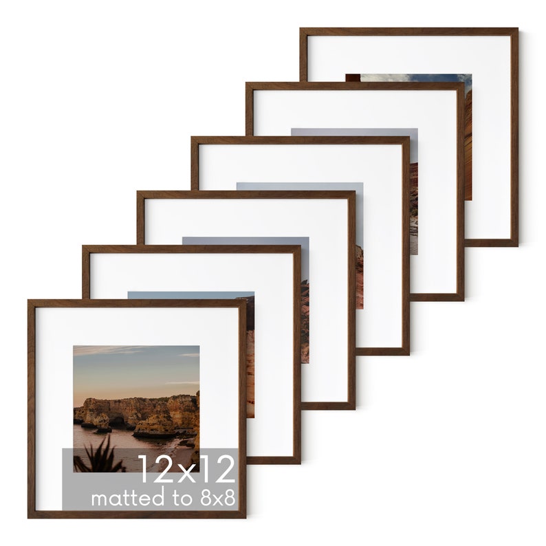 May include: Set of six brown wood picture frames, each with a white mat, arranged in a staggered pattern. The frames are 12x12 inches, matted to 8x8 inches.