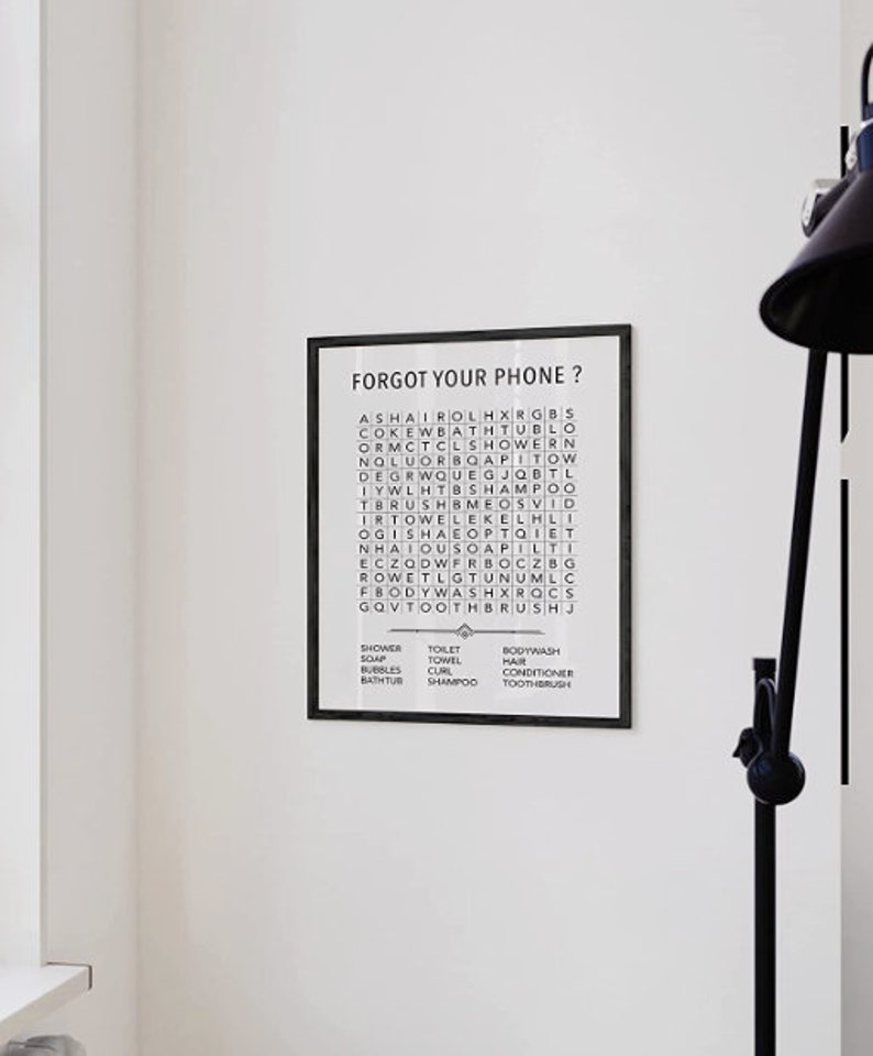 May include: Black and white framed print with the text "Forgot your phone?" and a word search puzzle with the words "shower, soap, bubbles, bathtub, toilet, towel, curl, shampoo, bodywash, hair, conditioner, toothbrush".